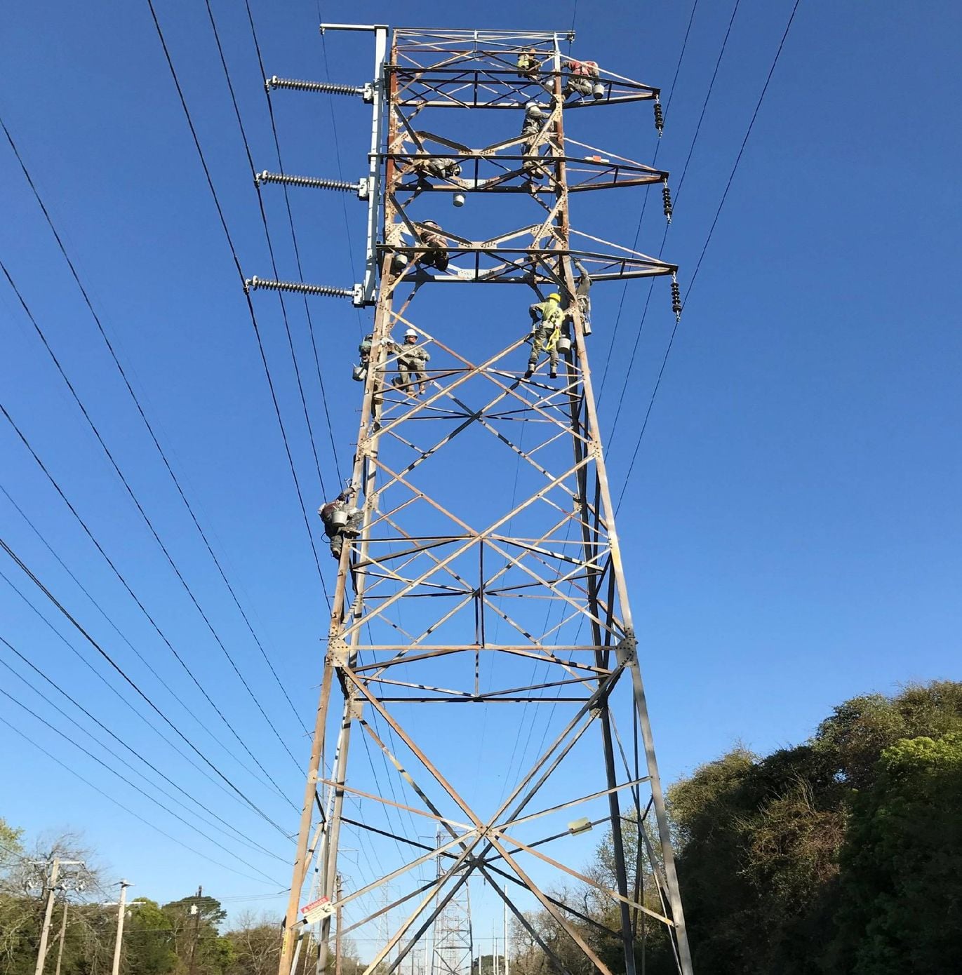 A transmission tower being painted with INDURAGUARD 9200